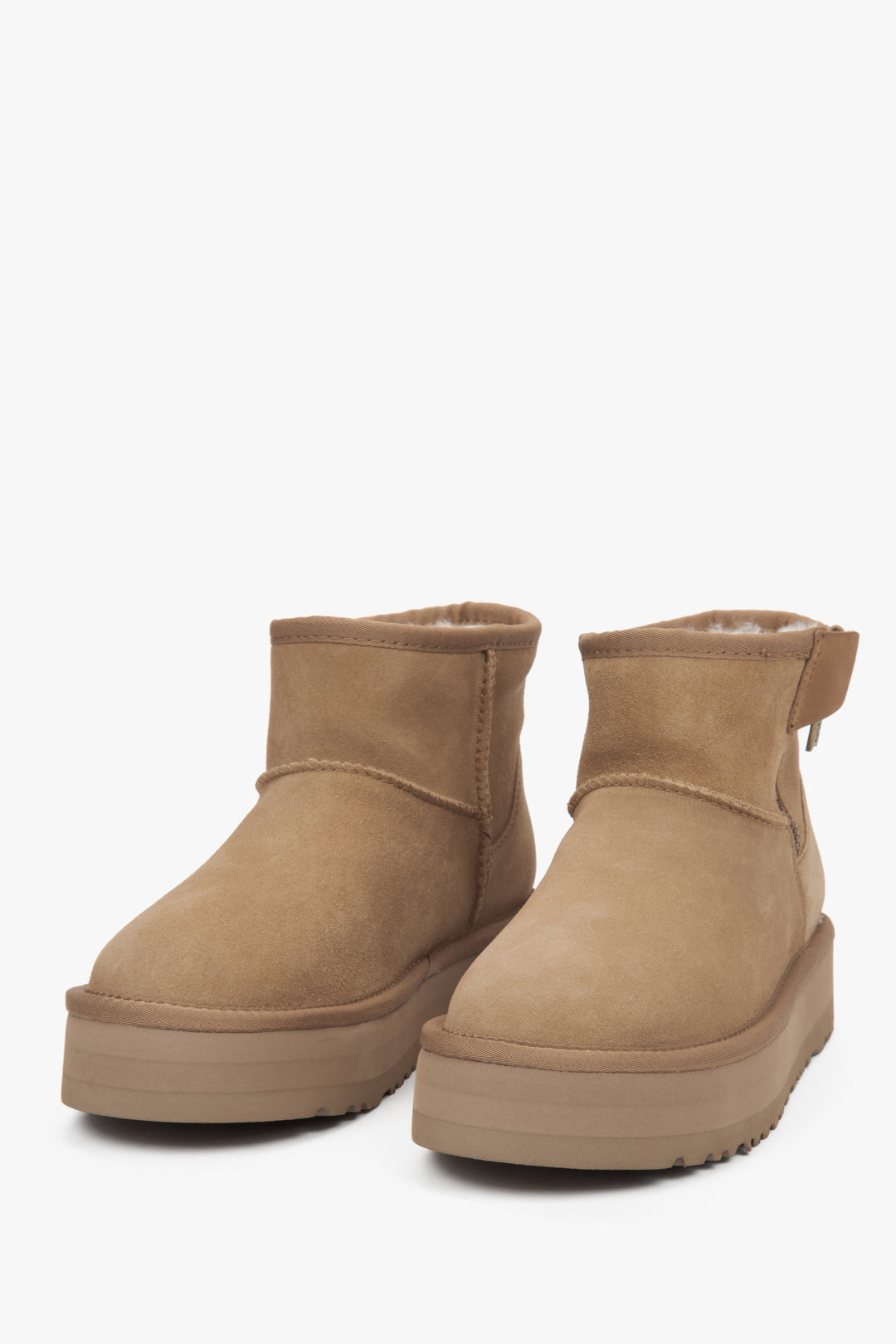 Elegant beige women’s snow boots made of genuine velour with a cozy fur lining.