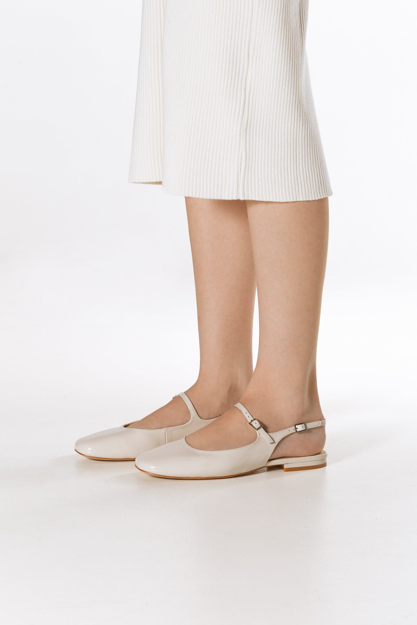 Hellbeige Slingback-Ballerinas aus Lackleder für Damen – Tragebild.