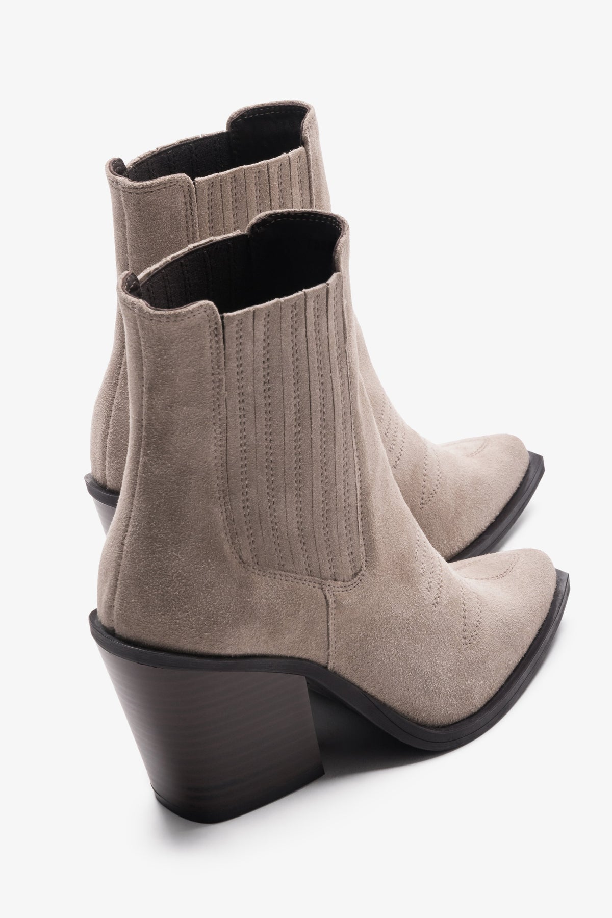Rückwärtige 3/4-Ansicht des Paares dunkelbeiger Velours-Boots mit Fokus auf den abgeschrägten Absatz