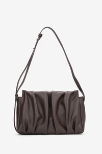 Frontalansicht der dunkelbraunen Damen-Crossbody-Tasche aus Echtleder mit vertikalen Raffungen von Estro