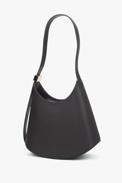 Schrägansicht der dunkelbraunen Schultertasche mit modern geschwungener Form und Lederriemen