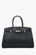 Frontansicht der eleganten schwarzen Leder-Tote-Bag mit goldfarbenem Verschlussdetail