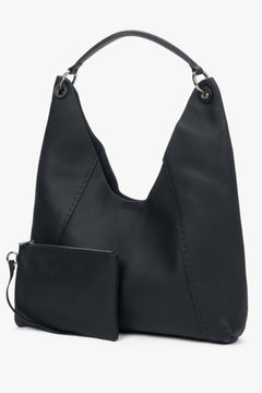 Die schwarze Ledertasche wird zusammen mit der praktischen, herausnehmbaren Kosmetiktasche präsentiert.