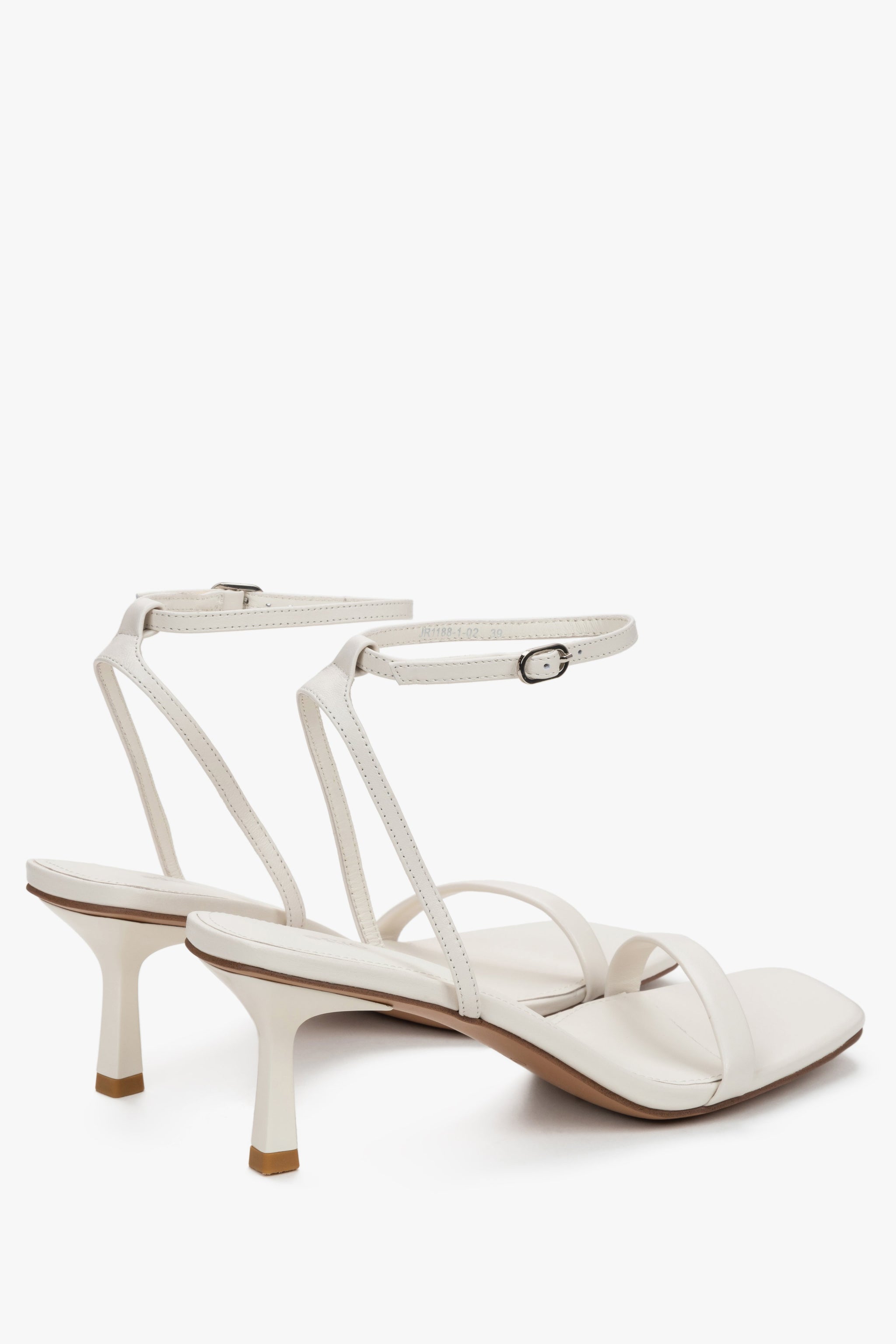 Milchbeige Damen-Sandaletten aus Leder in schräger Seitenansicht mit Schnallenverschluss