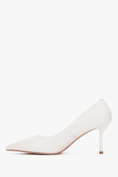 Sauberes Seitenprofil des linken milchbeigen Stilettos mit gummierter Sohle für optimalen Halt 