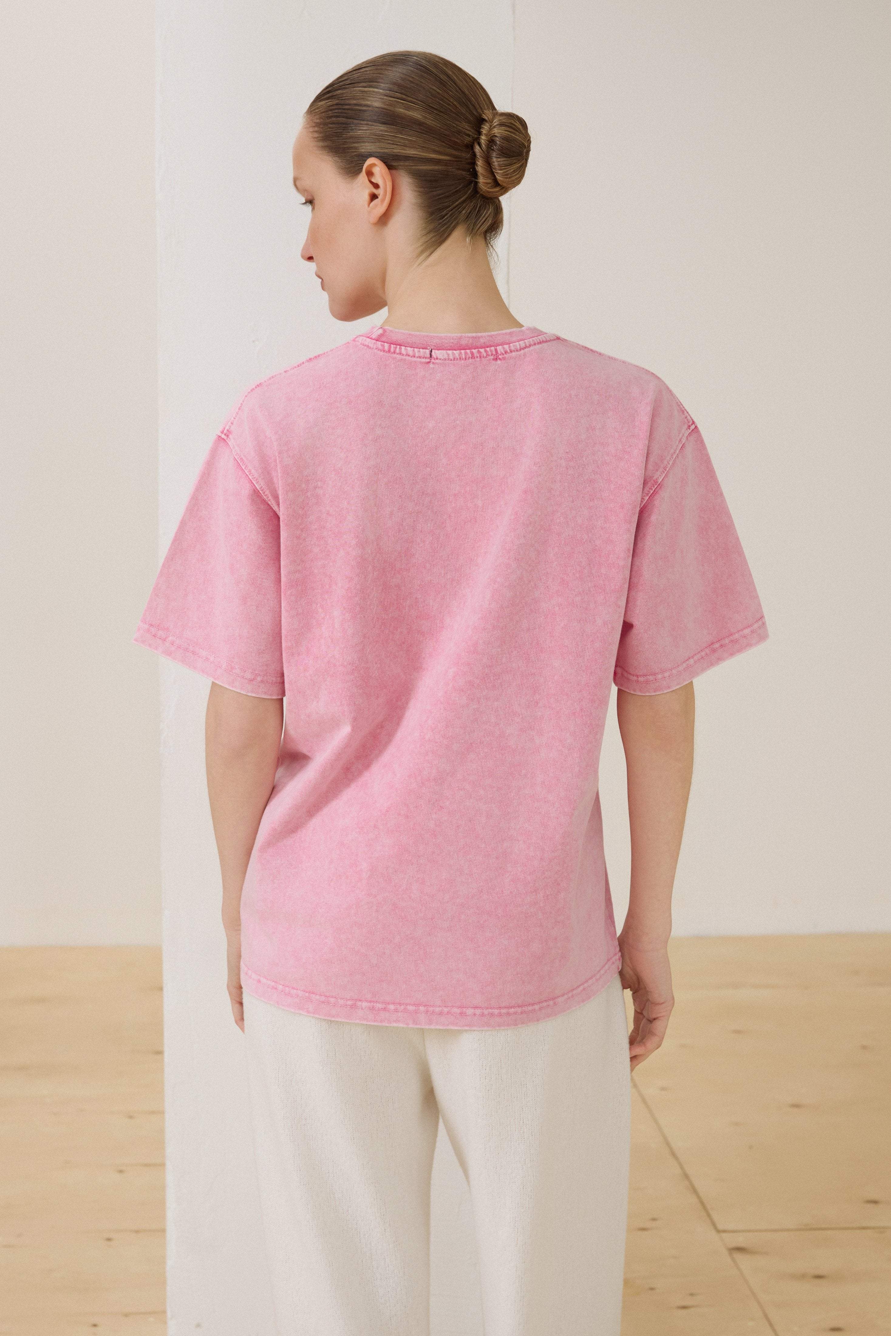 Rückansicht des rosa Oversize-T-Shirts im Acid-Wash-Look
