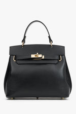 Frontale Ansicht der schwarzen Leder-Henkeltasche mit elegantem Goldverschluss und strukturiertem Finish 