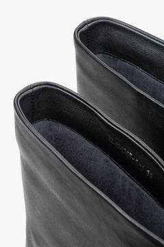 Detailaufnahme des Schaftrandes und des weichen, leicht wärmenden Flanellfutters im Inneren der schwarzen Stiefeletten
