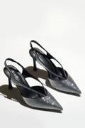 Zwei schwarze Slingback-Pumps mit funkelnden Kristallen auf hellem Hintergrund