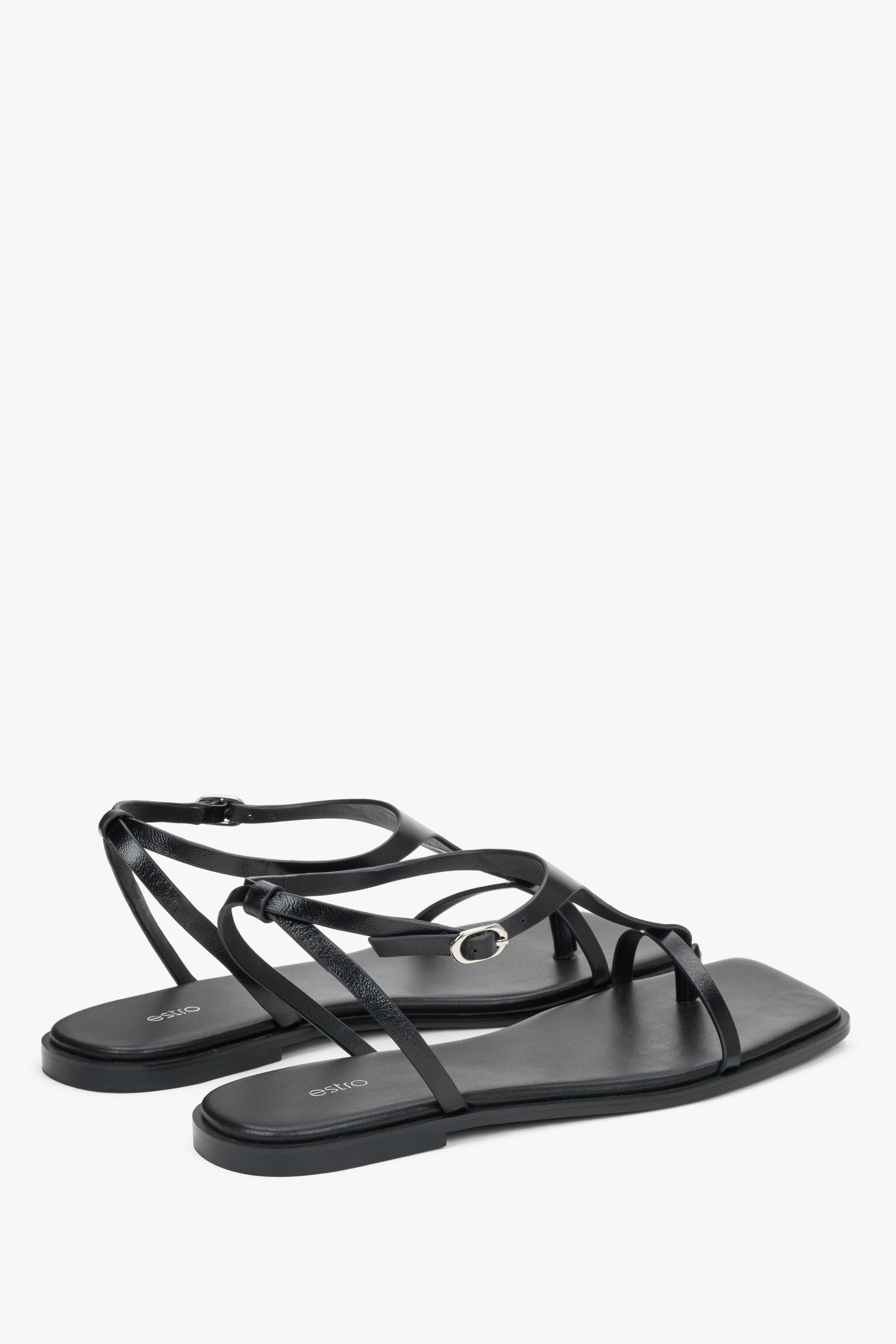 Schwarze flache Damen-Sandalen mit Zehentrenner in schräger Seitenansicht