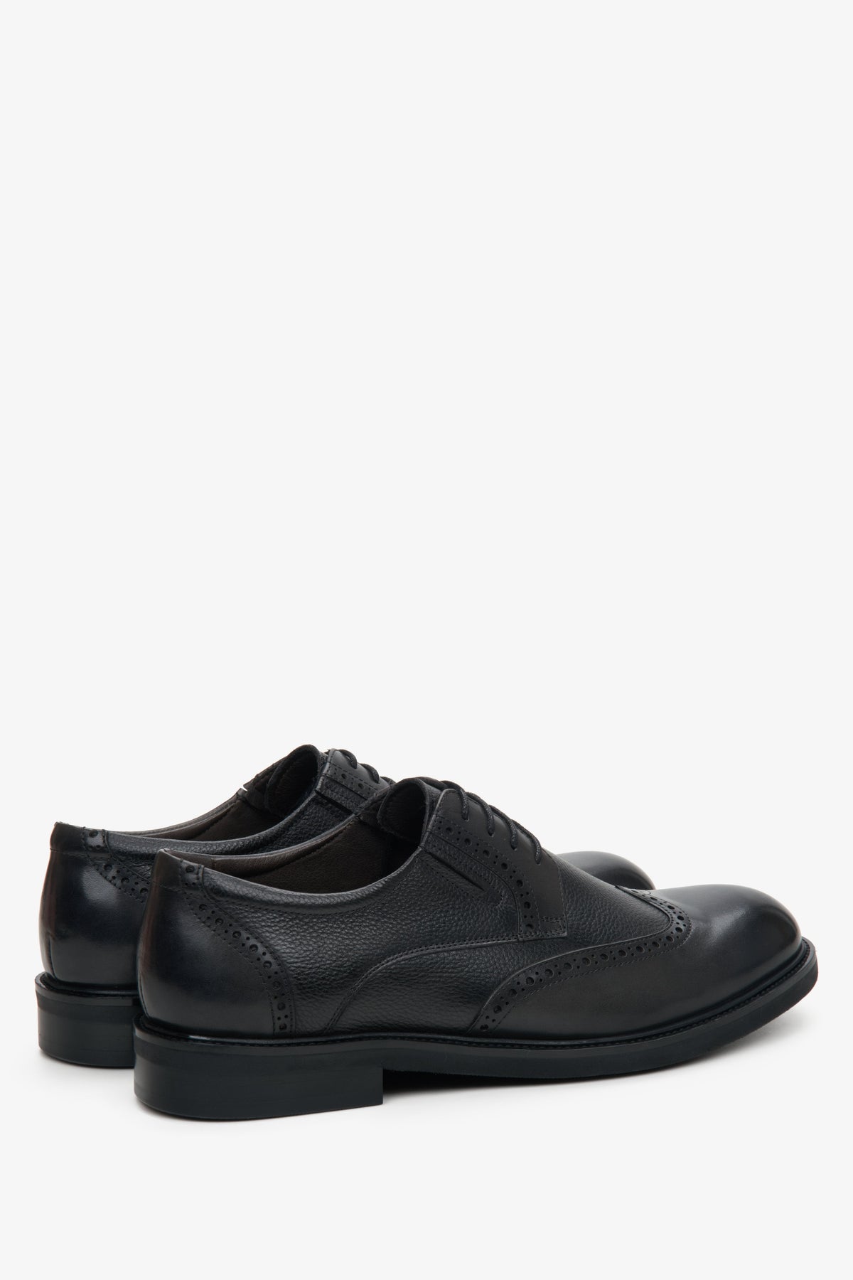 Schräge Rückansicht der schwarzen Herren-Halbschuhe aus Leder mit dekorativer Brogue-Perforation und flachem Absatz   