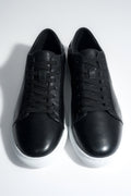 Draufsicht auf das Paar schwarzer Herren-Sneaker aus weichem Echtleder.