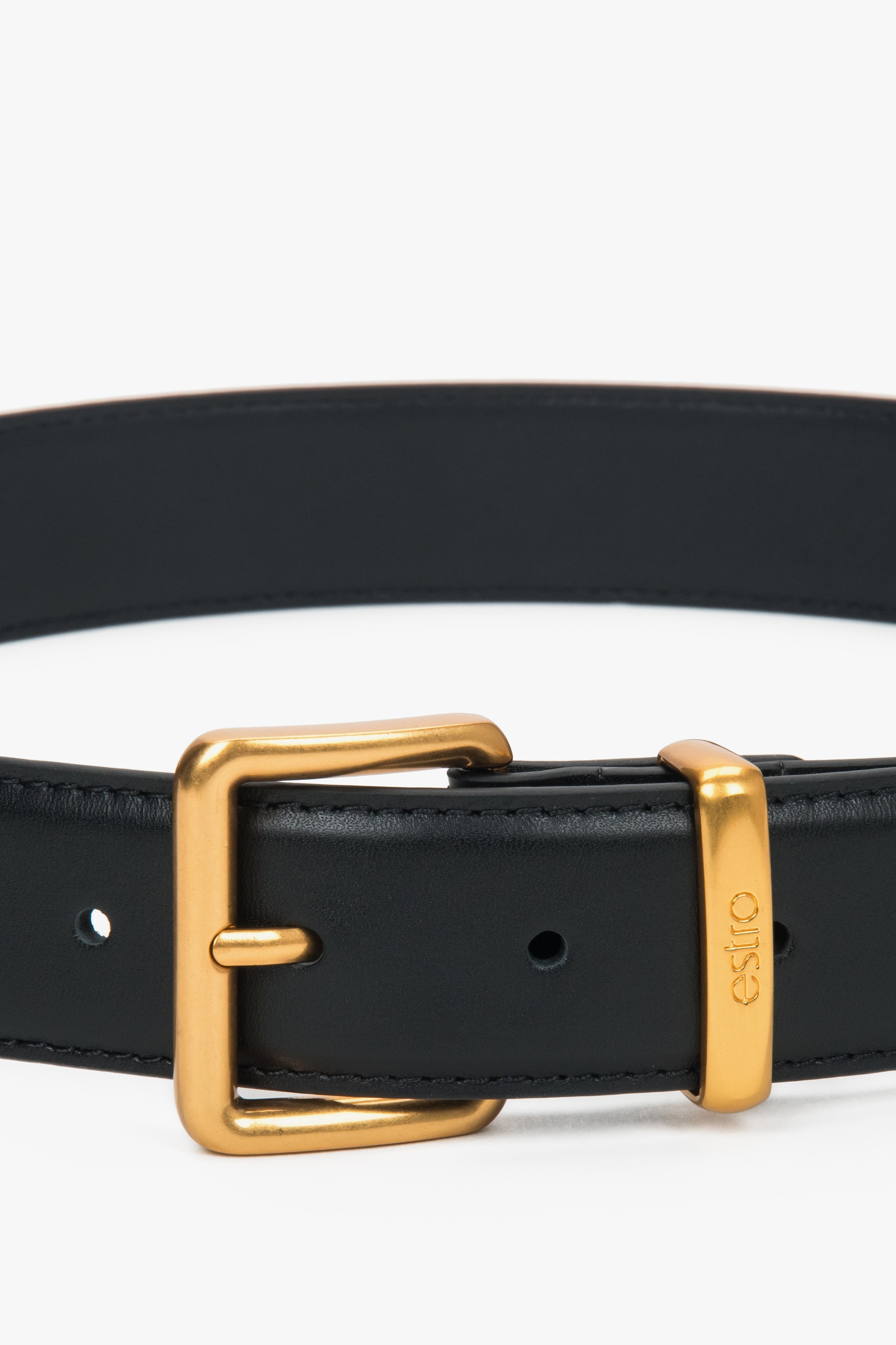 Nahaufnahme der eleganten, goldenen Dornschnalle und der Lederschlaufe mit Logo 