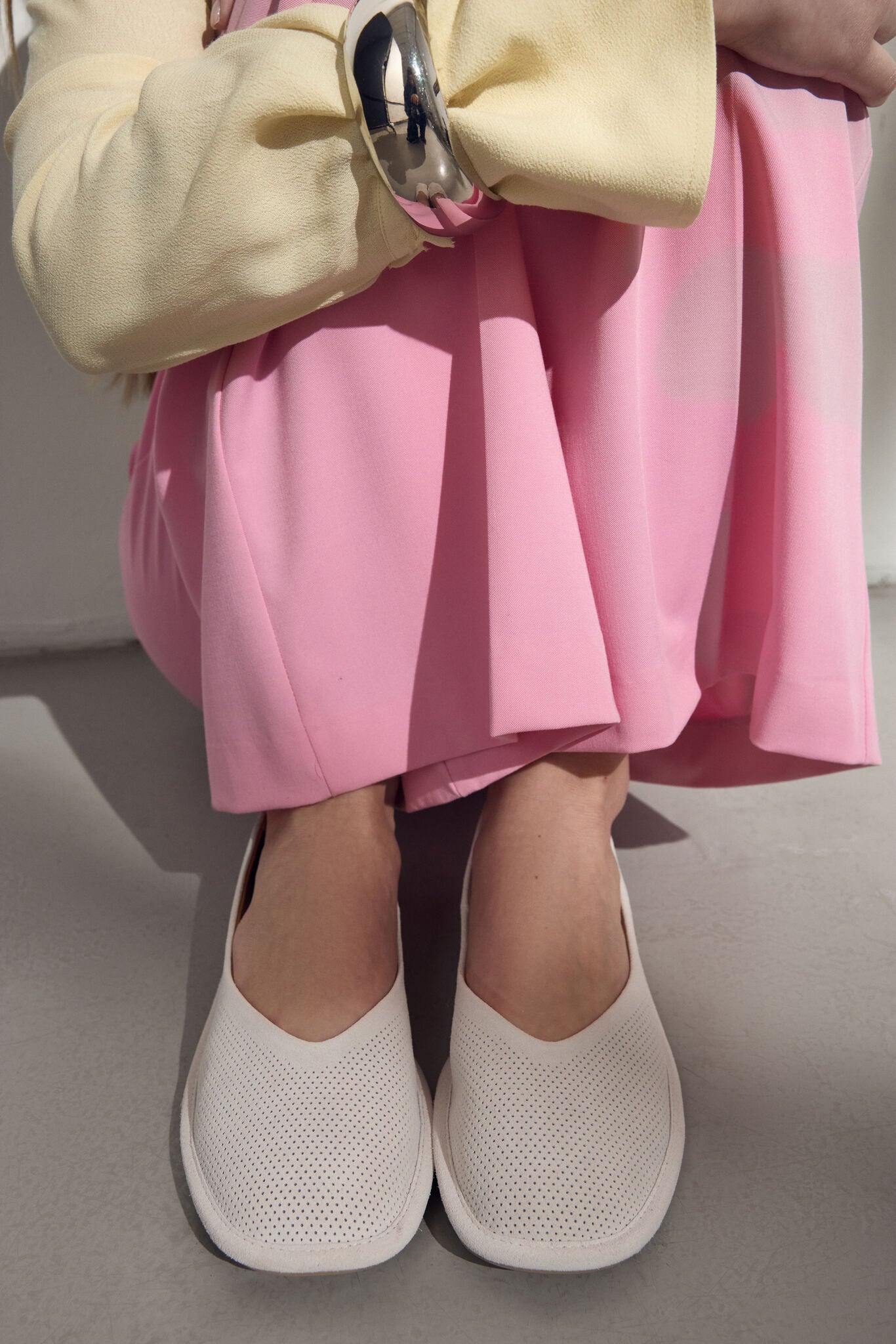 Lifestyle-Aufnahme der weißen Damen-Ballerinas am Model mit rosafarbener Hose